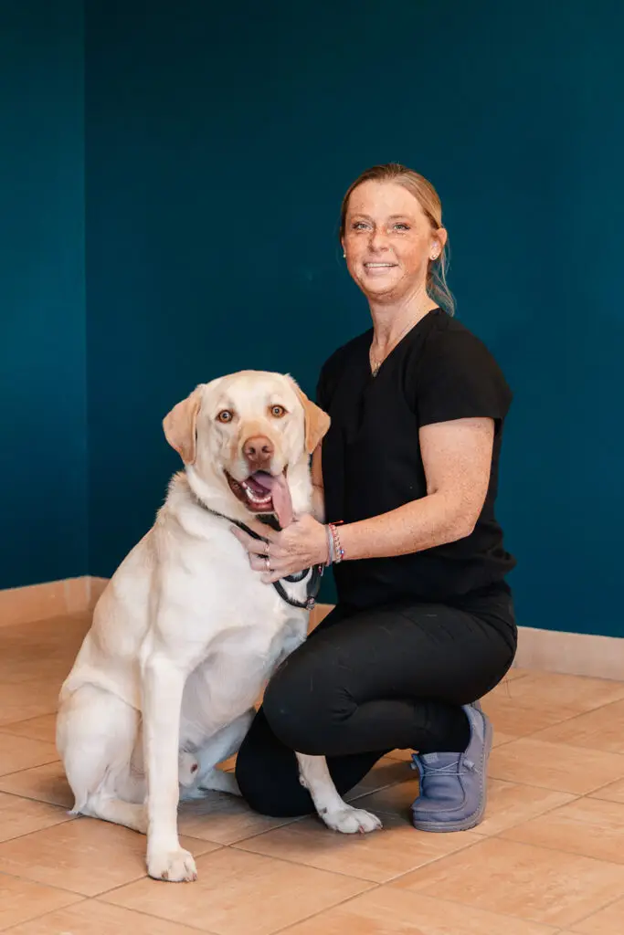 A Buckeystown Veterinary Hospital staff member poses witha yellow lab.